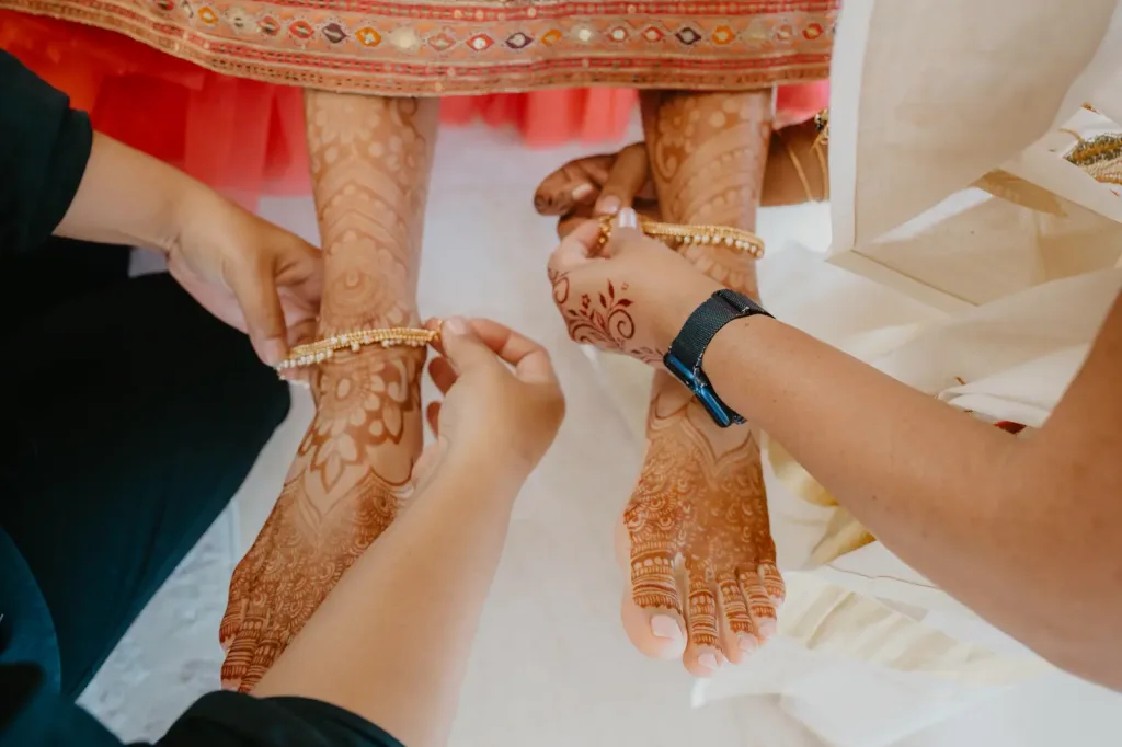 Mehndi being painted onto the bride’s feet