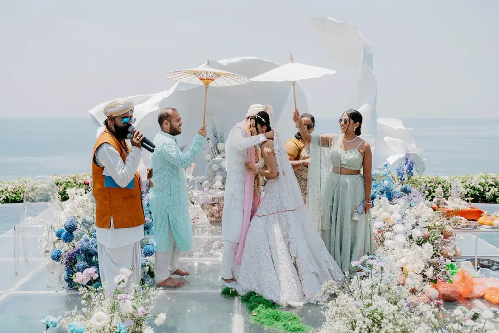 A pastel floral mandap set against the Indian Ocean at Pandawa Cliff Estate