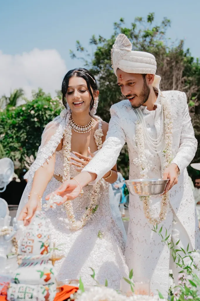 The couple photographed together after the ceremony, garlands still on