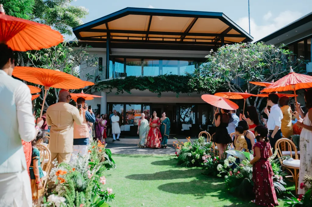 The venue set for the ceremony, orange parasols along the cliff lawn