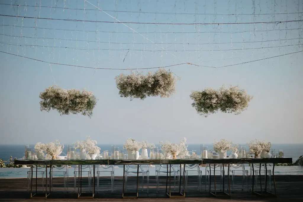 Suspended floral clouds above the long reception table