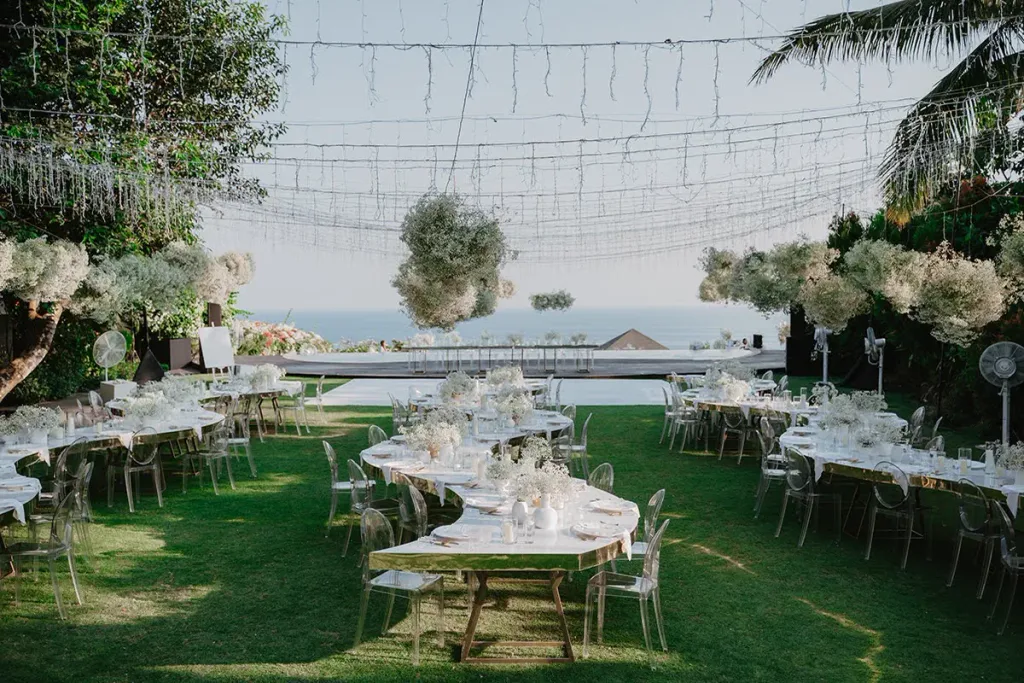 The reception tables on the lawn as the light drops