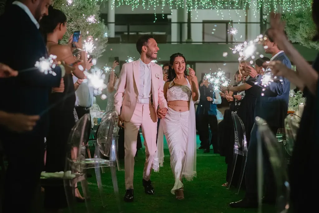 The couple walking out through a corridor of sparklers