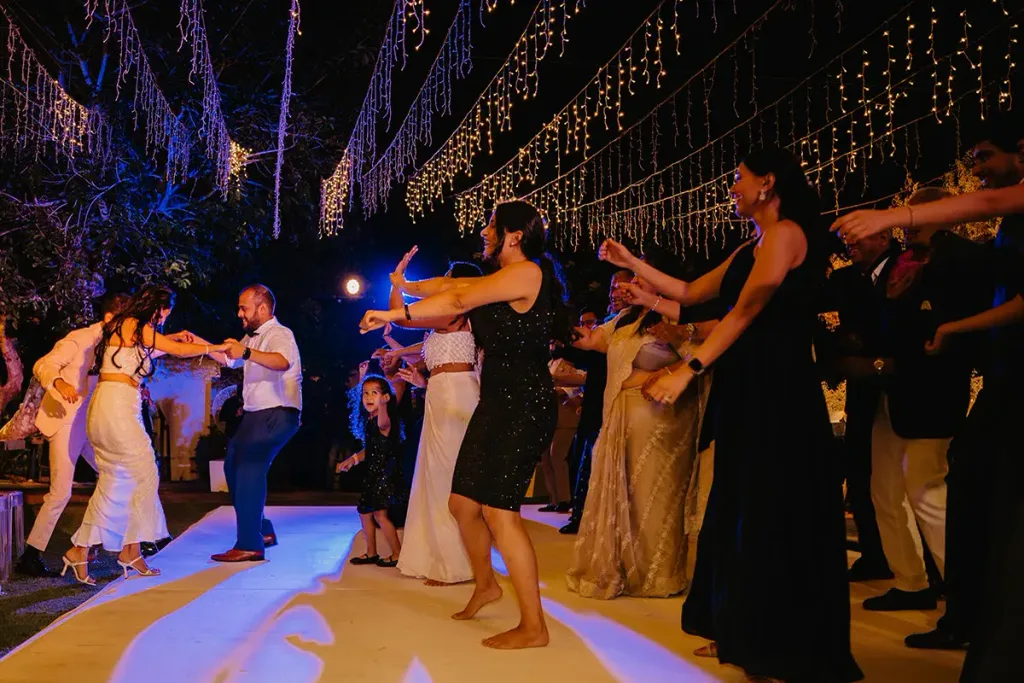 The dance floor under a canopy of fairy lights, guests mid-celebration