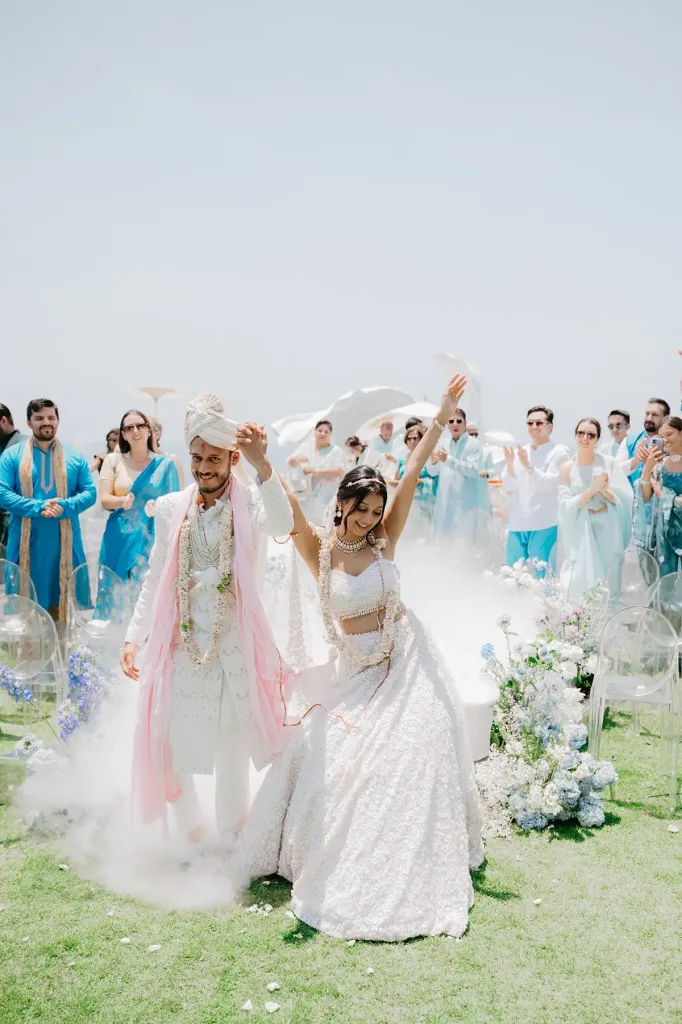 The couple heading back down the aisle to cheering guests