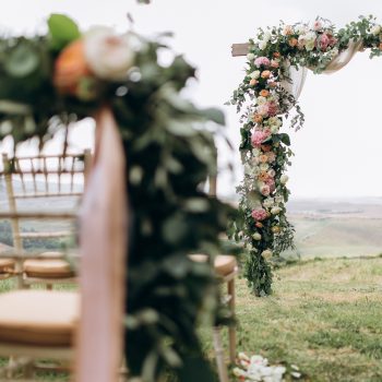 Beautiful arch decorated with eucalyptus and different fresh flowers